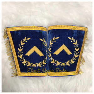 Blue House Worshipful Master Masonic Cuffs. Blue Velvet. Gold embroidered masonic symbol. Gold braided fringe trims the cuffs shown closed.