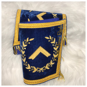 Blue House Worshipful Master Masonic Cuffs. Blue Velvet. Gold embroidered masonic symbol. Gold braided fringe trims the cuffs shown closed.