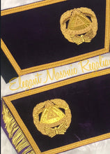 Load image into Gallery viewer, Deputy Grand Master Cuffs. Purple velvet. Gold embroidered masonic symbol. Gold braided fringe trims the cuffs shown open.
