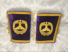 Load image into Gallery viewer, Grand Senior Warden Masonic (Event) Cuffs. Purple velvet. Gold bullion and braided edges and fringe. Embroidered masonic symbol. Design outlined in 100% Swarovski Crystals.
