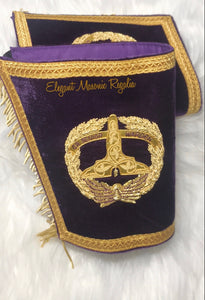 Grand Senior Warden Masonic Cuffs. Purple velvet. Gold embroidered masonic symbol. Gold braided fringe trims the cuffs shown closed.