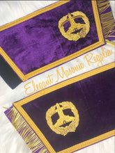 Load image into Gallery viewer, Grand Senior Warden Masonic Cuffs. Purple velvet. Gold embroidered masonic symbol. Gold braided fringe trims the cuffs shown open.
