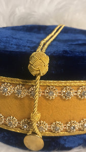 Up close view of the Worshipful Master Masonic Crown (Blue House). Embroidered masonic symbol. Blue velvet. Gold rope to adjust size of cap.